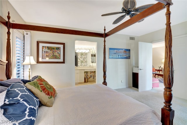 carpeted bedroom with beamed ceiling, ceiling fan, and ensuite bathroom