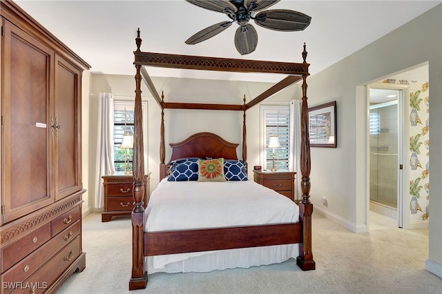 carpeted bedroom with ceiling fan and ensuite bathroom