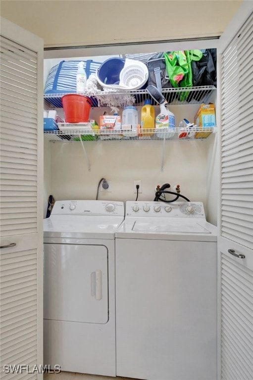 clothes washing area with washer and dryer