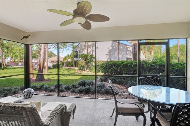 sunroom featuring ceiling fan