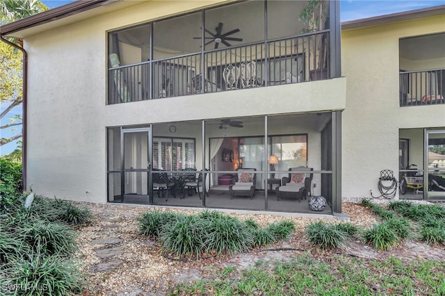 back of property with a balcony