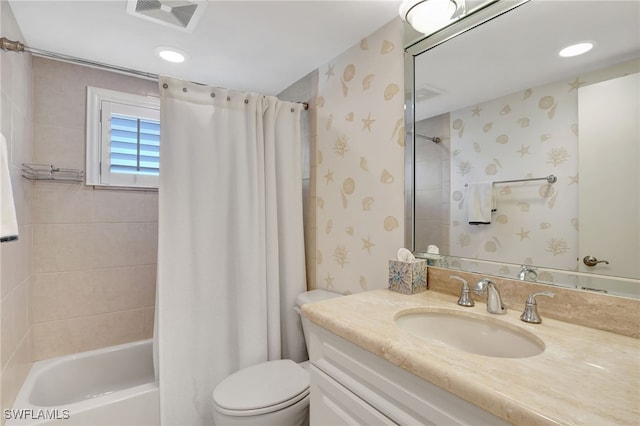 full bathroom featuring shower / tub combo with curtain, vanity, and toilet