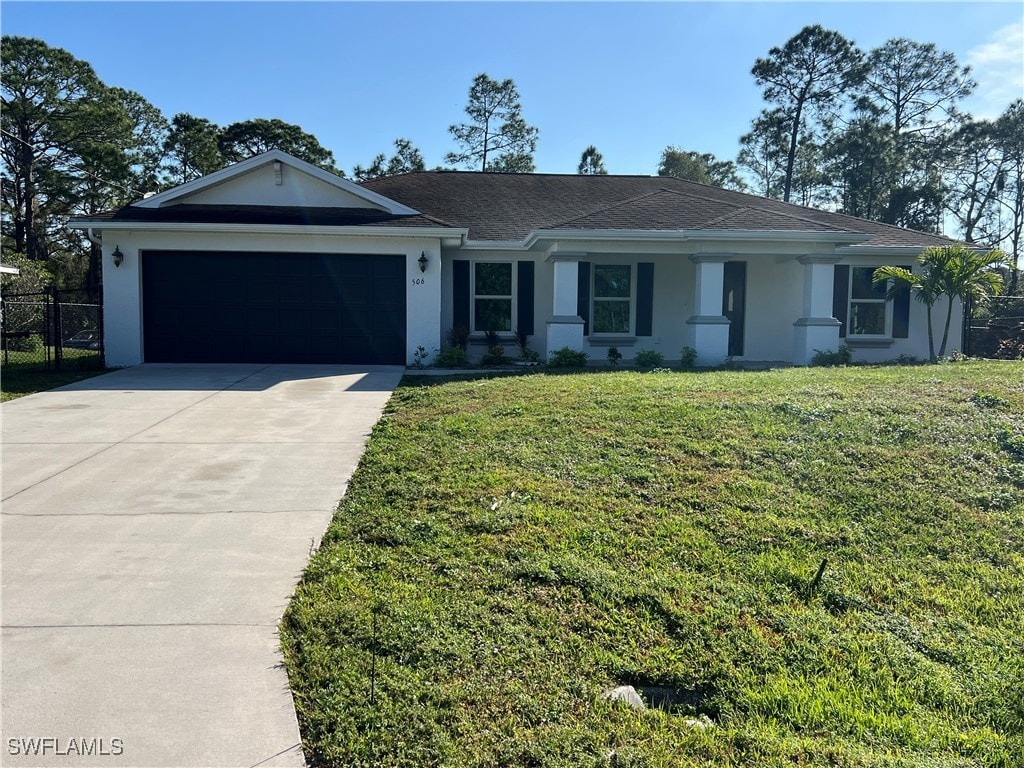 single story home with a garage and a front yard