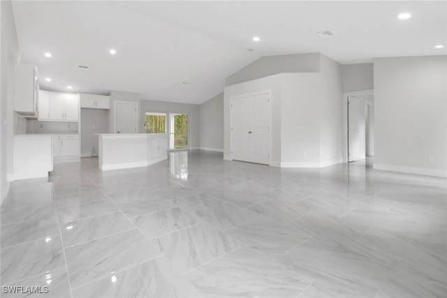 unfurnished living room featuring lofted ceiling, marble finish floor, baseboards, and recessed lighting