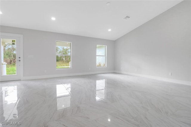 empty room featuring lofted ceiling, recessed lighting, visible vents, baseboards, and marble finish floor