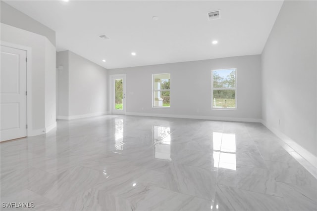 empty room with baseboards, visible vents, and recessed lighting