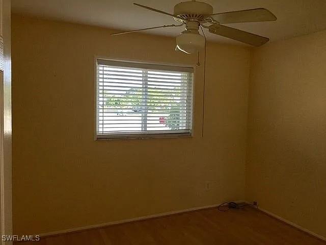 spare room featuring hardwood / wood-style flooring and ceiling fan