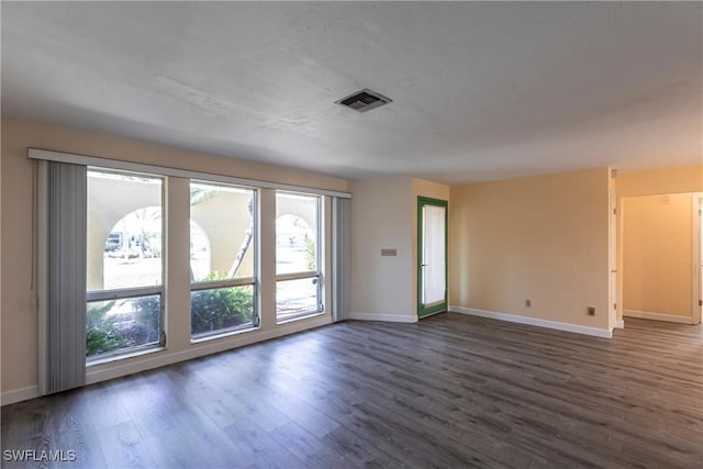 empty room featuring dark hardwood / wood-style flooring