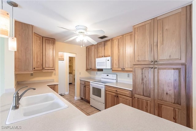 kitchen featuring sink, white appliances, hanging light fixtures, light tile patterned floors, and ceiling fan