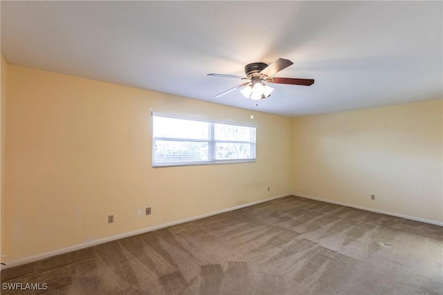 carpeted empty room featuring ceiling fan