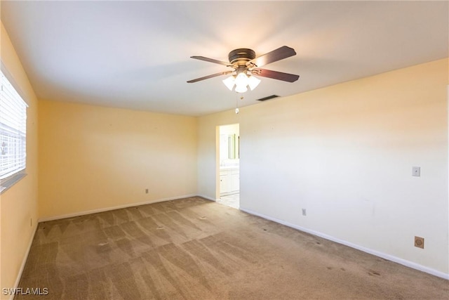 spare room featuring carpet floors and ceiling fan