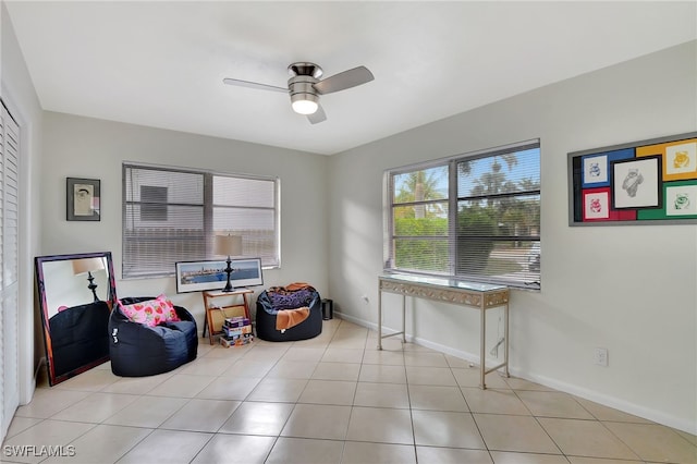 sitting room with ceiling fan and light tile patterned floors