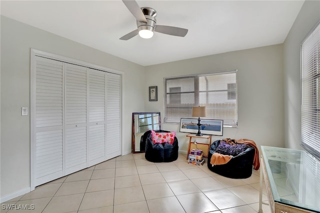 sitting room featuring ceiling fan and light tile patterned floors