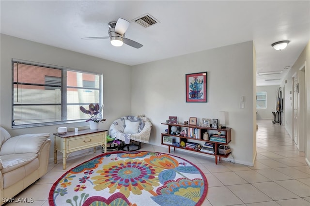 sitting room with light tile patterned floors and ceiling fan