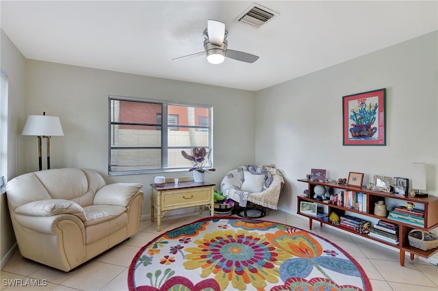 sitting room with ceiling fan and light tile patterned floors