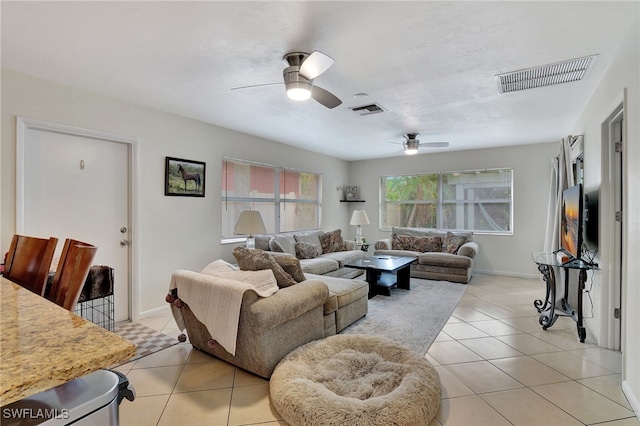 living room featuring ceiling fan and light tile patterned floors