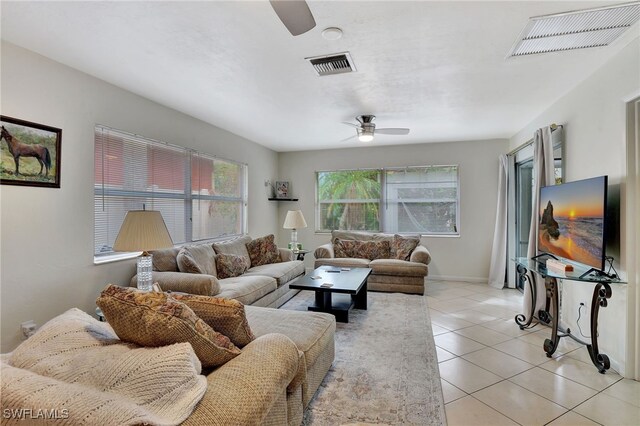 tiled living room featuring ceiling fan