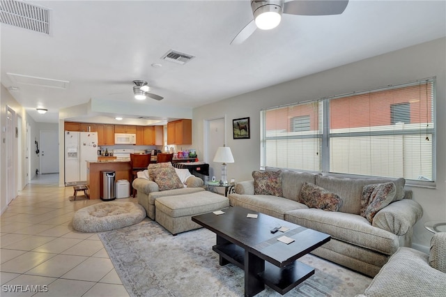 living room featuring ceiling fan and light tile patterned flooring