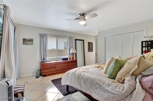 tiled bedroom with a closet and ceiling fan