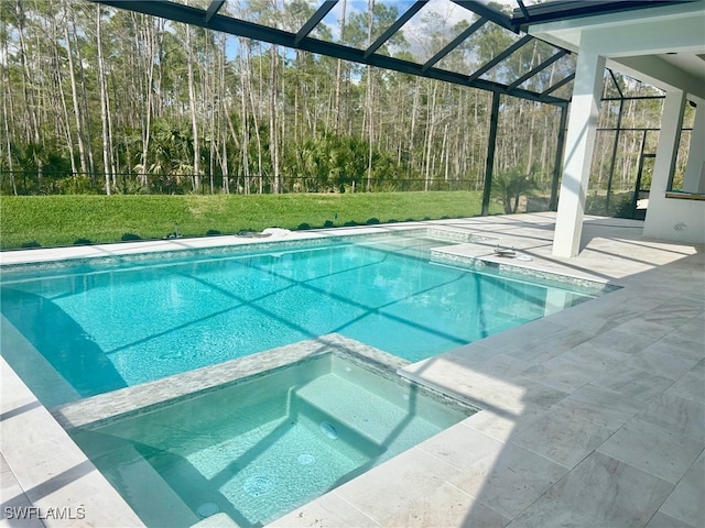 view of swimming pool with glass enclosure, a pool with connected hot tub, a lawn, and a patio