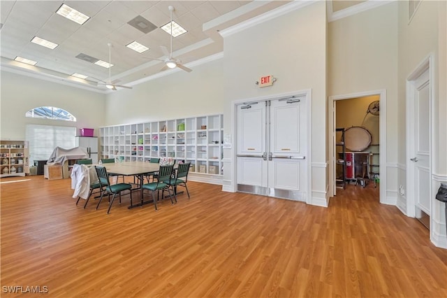 20037 Serene Meadow Ln, Estero, FL 33928 - dining room featuring a high ceiling, ornamental molding, light wood-type flooring, and ceiling fan