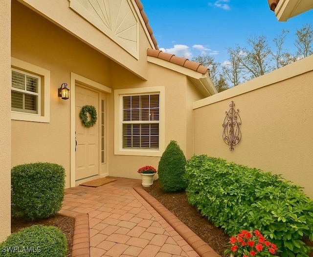 20037 Serene Meadow Ln, Estero, FL 33928 - view of exterior entry featuring stucco siding
