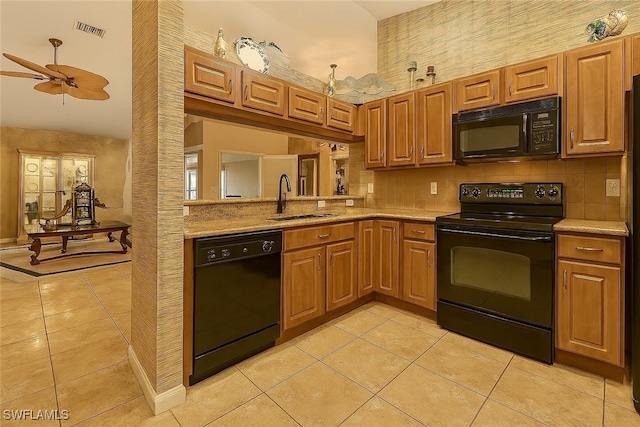 20037 Serene Meadow Ln, Estero, FL 33928 - kitchen with black appliances, light tile patterned floors, a high ceiling, brown cabinetry, and backsplash