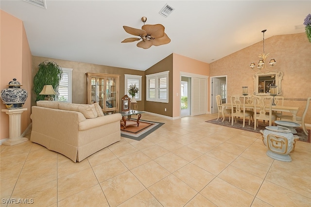 20037 Serene Meadow Ln, Estero, FL 33928 - tiled living room featuring a ceiling fan, a chandelier, and high vaulted ceiling