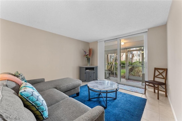 tiled living room featuring floor to ceiling windows and a textured ceiling