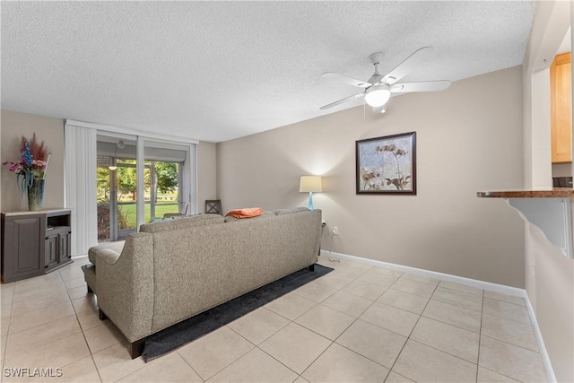 living room with light tile patterned floors, a textured ceiling, and ceiling fan