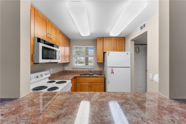 kitchen featuring sink and white appliances