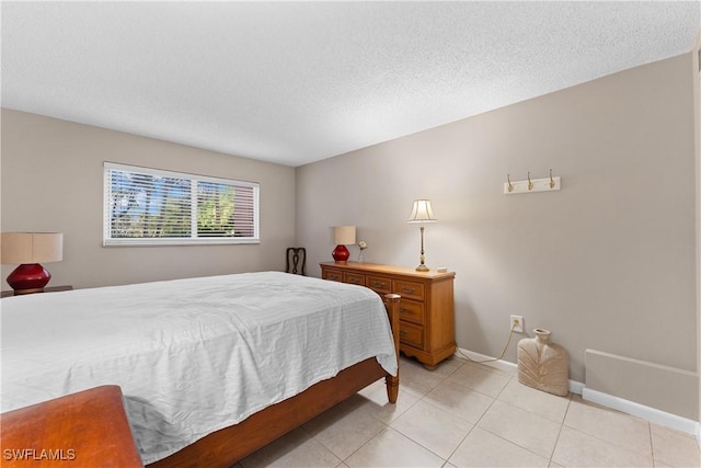 tiled bedroom featuring a textured ceiling