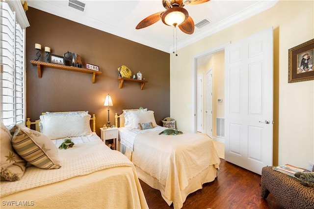 bedroom with ornamental molding, dark hardwood / wood-style floors, and ceiling fan