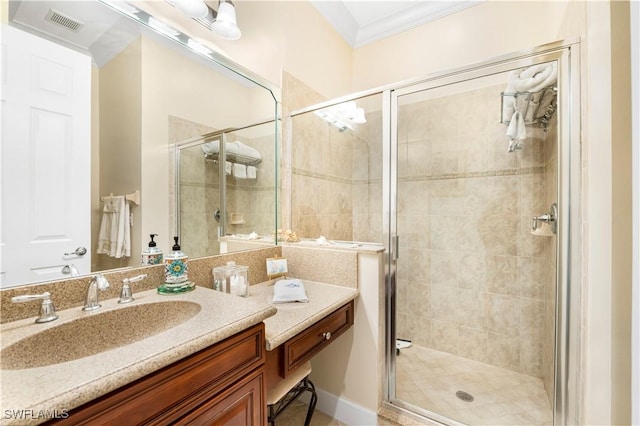 bathroom with vanity, ornamental molding, and walk in shower