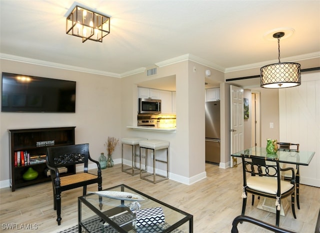 living room with crown molding and light hardwood / wood-style floors