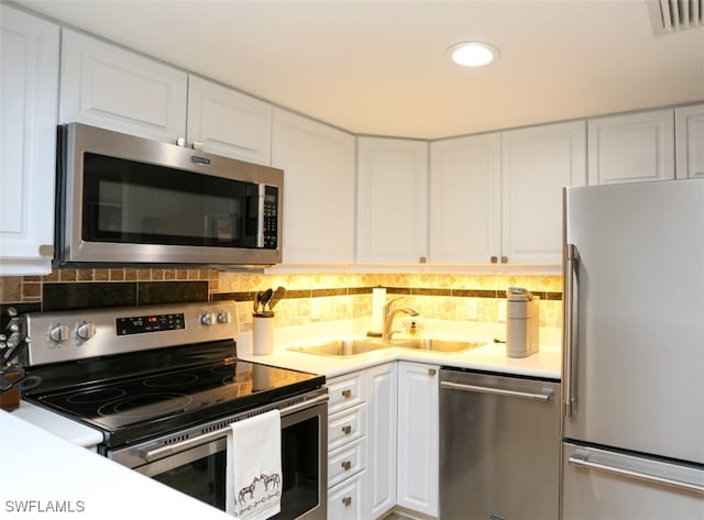 kitchen featuring white cabinetry, appliances with stainless steel finishes, sink, and tasteful backsplash