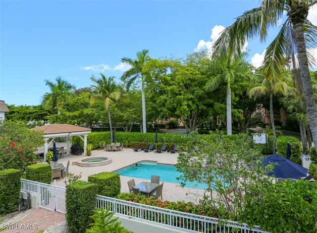 view of swimming pool featuring a gazebo, an in ground hot tub, and a patio