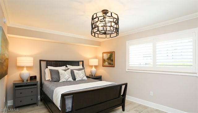 bedroom with hardwood / wood-style flooring, ornamental molding, and a notable chandelier