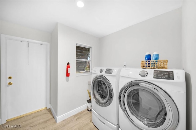 washroom with light hardwood / wood-style floors and independent washer and dryer