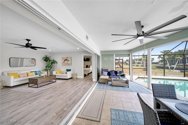 living room featuring ceiling fan and light hardwood / wood-style flooring