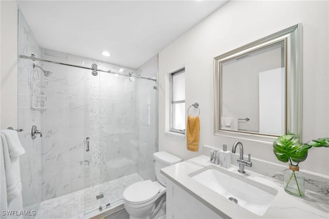 bathroom with vanity, toilet, and an enclosed shower