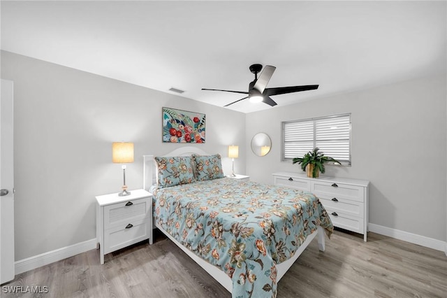 bedroom with light hardwood / wood-style flooring and ceiling fan