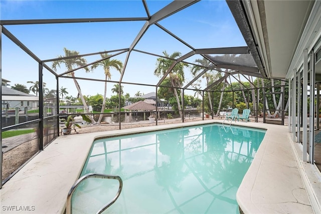 view of pool with a patio and a lanai