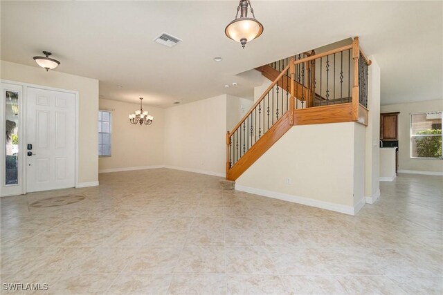 unfurnished living room with stairs, a chandelier, baseboards, tile patterned flooring, and visible vents