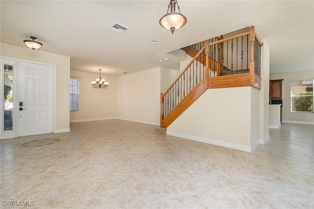 10188 Mimosa Silk Dr, Fort Myers, FL 33913 - unfurnished living room with visible vents, baseboards, tile patterned floors, a notable chandelier, and stairs
