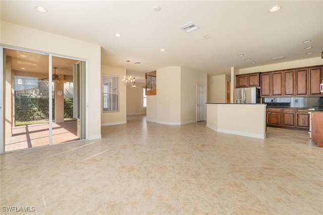 unfurnished living room with baseboards, visible vents, recessed lighting, a chandelier, and light tile patterned floors
