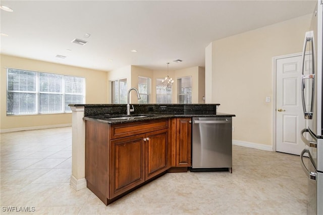 kitchen with appliances with stainless steel finishes, a sink, visible vents, and light tile patterned floors