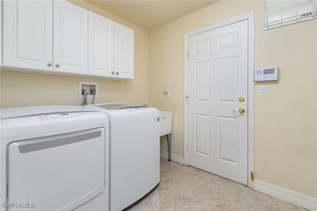 clothes washing area featuring cabinet space, baseboards, light tile patterned flooring, and separate washer and dryer