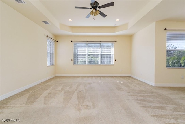 10188 Mimosa Silk Dr, Fort Myers, FL 33913 - empty room featuring light colored carpet, a raised ceiling, and a wealth of natural light