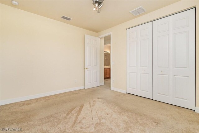 10188 Mimosa Silk Dr, Fort Myers, FL 33913 - unfurnished bedroom with visible vents, baseboards, a closet, and light colored carpet